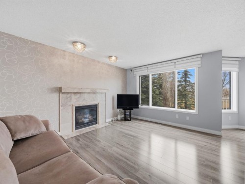 247 Hidden Valley Place Nw, Calgary, AB - Indoor Photo Showing Living Room With Fireplace