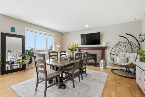 99 Sunset View, Cochrane, AB - Indoor Photo Showing Dining Room With Fireplace
