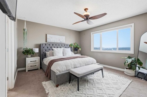 99 Sunset View, Cochrane, AB - Indoor Photo Showing Bedroom
