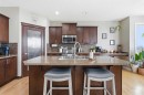 99 Sunset View, Cochrane, AB  - Indoor Photo Showing Kitchen With Stainless Steel Kitchen With Double Sink With Upgraded Kitchen 