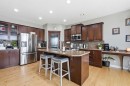 99 Sunset View, Cochrane, AB  - Indoor Photo Showing Kitchen With Stainless Steel Kitchen With Double Sink 