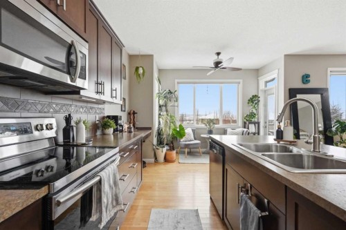 99 Sunset View, Cochrane, AB - Indoor Photo Showing Kitchen With Stainless Steel Kitchen With Double Sink With Upgraded Kitchen