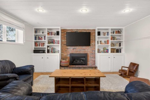 2507 Chicoutimi Drive Nw, Calgary, AB - Indoor Photo Showing Living Room With Fireplace