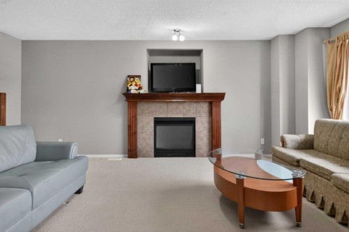 135 Copperstone Grove Se, Calgary, AB - Indoor Photo Showing Living Room With Fireplace