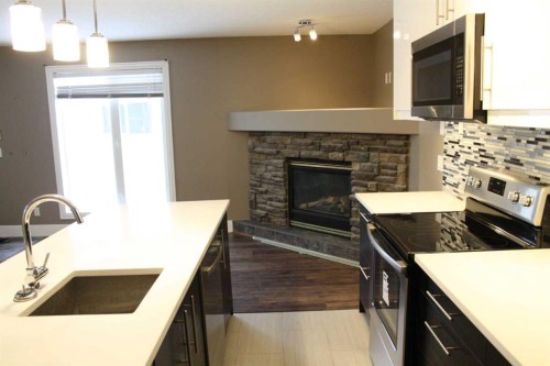 37 Chaparral Ridge Link Se, Calgary, AB - Indoor Photo Showing Kitchen With Fireplace With Upgraded Kitchen