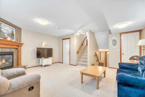 280 Cramond Close Se, Calgary, AB - Indoor Photo Showing Living Room With Fireplace