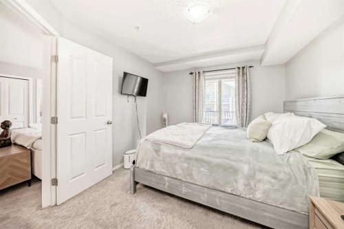 1305-403 Mackenzie Way Sw, Airdrie, AB - Indoor Photo Showing Bedroom