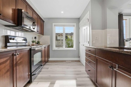 52 Windstone Green Sw, Airdrie, AB - Indoor Photo Showing Kitchen With Upgraded Kitchen