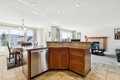 63 Westmount Circle, Okotoks, AB - Indoor Photo Showing Other Room With Fireplace