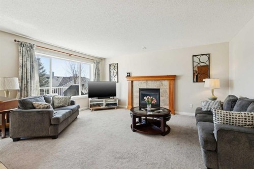 63 Westmount Circle, Okotoks, AB - Indoor Photo Showing Living Room With Fireplace