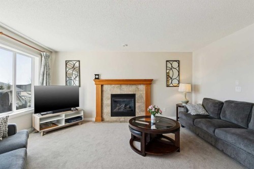 63 Westmount Circle, Okotoks, AB - Indoor Photo Showing Living Room With Fireplace