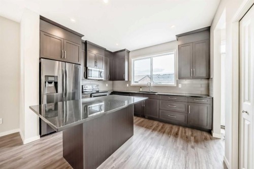 18 Willow Crescent, Okotoks, AB - Indoor Photo Showing Kitchen With Upgraded Kitchen