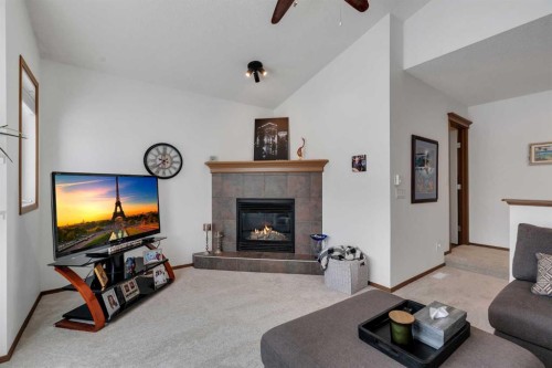 265 Bridlemeadows Common Sw, Calgary, AB - Indoor Photo Showing Living Room With Fireplace