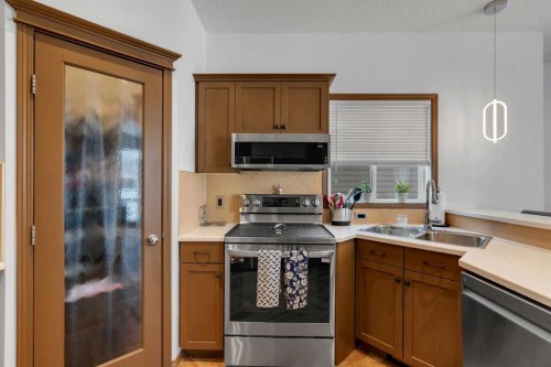 265 Bridlemeadows Common Sw, Calgary, AB - Indoor Photo Showing Kitchen With Double Sink