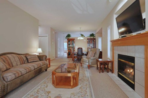 13 Scimitar Heath Nw, Calgary, AB - Indoor Photo Showing Living Room With Fireplace