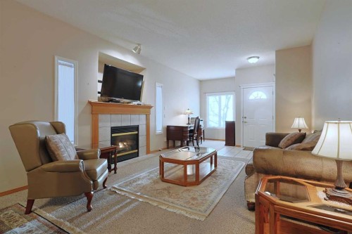 13 Scimitar Heath Nw, Calgary, AB - Indoor Photo Showing Living Room With Fireplace