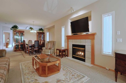 13 Scimitar Heath Nw, Calgary, AB - Indoor Photo Showing Living Room With Fireplace