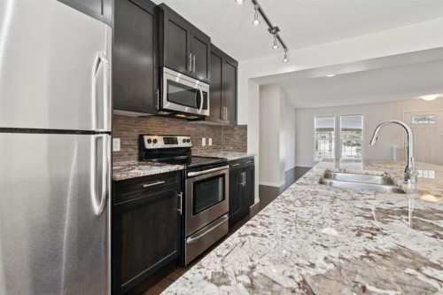 10 Auburn Bay Common Se, Calgary, AB - Indoor Photo Showing Kitchen With Stainless Steel Kitchen With Double Sink With Upgraded Kitchen