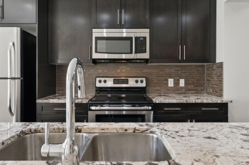 10 Auburn Bay Common Se, Calgary, AB - Indoor Photo Showing Kitchen With Stainless Steel Kitchen With Double Sink With Upgraded Kitchen