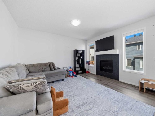 62 Yorkstone Heath Sw, Calgary, AB - Indoor Photo Showing Living Room With Fireplace