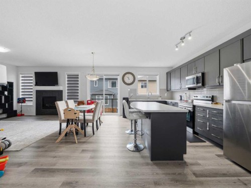 62 Yorkstone Heath Sw, Calgary, AB - Indoor Photo Showing Kitchen With Fireplace