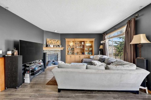 765 Qualicum Beach Bay, Chestermere, AB - Indoor Photo Showing Living Room With Fireplace