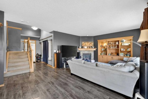 765 Qualicum Beach Bay, Chestermere, AB - Indoor Photo Showing Living Room With Fireplace