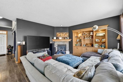 765 Qualicum Beach Bay, Chestermere, AB - Indoor Photo Showing Living Room With Fireplace