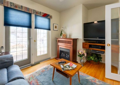 38 Spokane Street Sw, Calgary, AB - Indoor Photo Showing Living Room With Fireplace