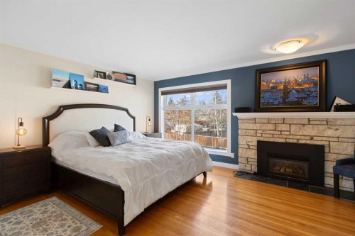 656 Willow Brook Drive Se, Calgary, AB - Indoor Photo Showing Bedroom With Fireplace