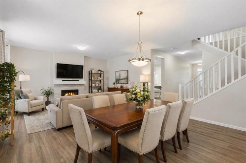 33 Carringham Heights Nw, Calgary, AB - Indoor Photo Showing Dining Room With Fireplace