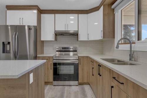 99 Dovercliffe Way Se, Calgary, AB - Indoor Photo Showing Kitchen With Double Sink With Upgraded Kitchen