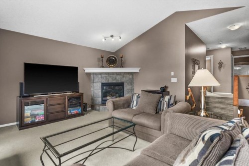 66 Tuscany Reserve Gate Nw, Calgary, AB - Indoor Photo Showing Living Room With Fireplace