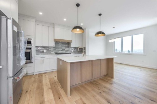 495 Rivercrest View, Cochrane, AB - Indoor Photo Showing Kitchen With Upgraded Kitchen
