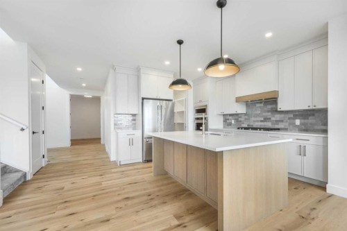 495 Rivercrest View, Cochrane, AB - Indoor Photo Showing Kitchen With Upgraded Kitchen