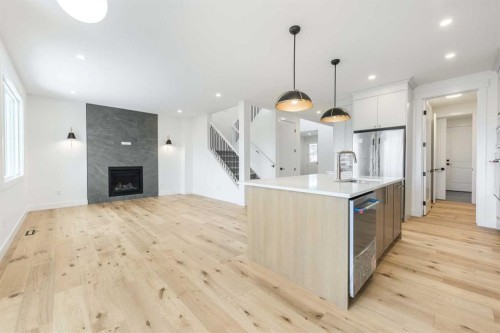 495 Rivercrest View, Cochrane, AB - Indoor Photo Showing Kitchen With Fireplace With Upgraded Kitchen