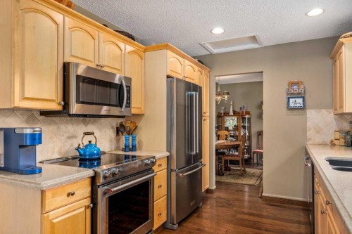 94 Sunset Way, Priddis Greens, AB - Indoor Photo Showing Kitchen With Stainless Steel Kitchen With Double Sink