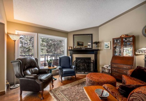 94 Sunset Way, Priddis Greens, AB - Indoor Photo Showing Living Room With Fireplace