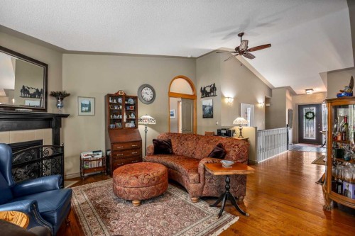 94 Sunset Way, Priddis Greens, AB - Indoor Photo Showing Living Room With Fireplace