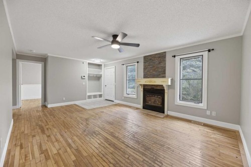 30338 Range Road 282, Rural Mountain View County, AB - Indoor Photo Showing Living Room With Fireplace