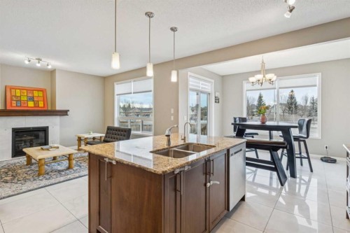 71 Walden Manor Se, Calgary, AB - Indoor Photo Showing Kitchen With Fireplace With Double Sink