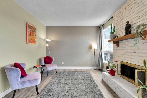 44 Strathclair Rise Sw, Calgary, AB - Indoor Photo Showing Living Room With Fireplace