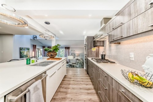 22 Coach Manor Terrace Sw, Calgary, AB - Indoor Photo Showing Kitchen With Double Sink With Upgraded Kitchen
