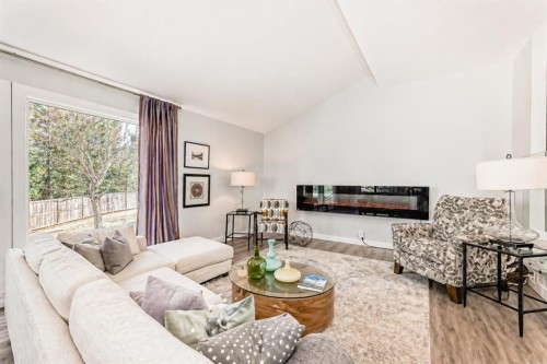 22 Coach Manor Terrace Sw, Calgary, AB - Indoor Photo Showing Living Room With Fireplace