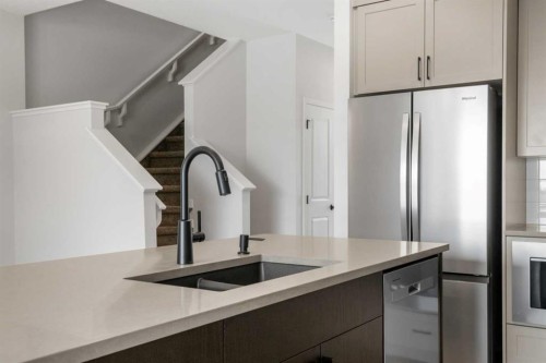 213 Bridgeport Gate, Chestermere, AB - Indoor Photo Showing Kitchen With Double Sink