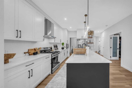11 Heritage Circle, Cochrane, AB - Indoor Photo Showing Kitchen With Upgraded Kitchen