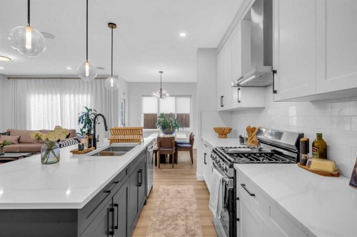 11 Heritage Circle, Cochrane, AB - Indoor Photo Showing Kitchen With Double Sink With Upgraded Kitchen