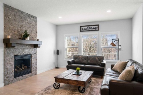 99 Ridge View Close, Cochrane, AB - Indoor Photo Showing Living Room With Fireplace