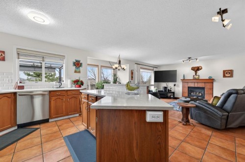 197 Arbour Stone Close Nw, Calgary, AB - Indoor Photo Showing Kitchen With Fireplace