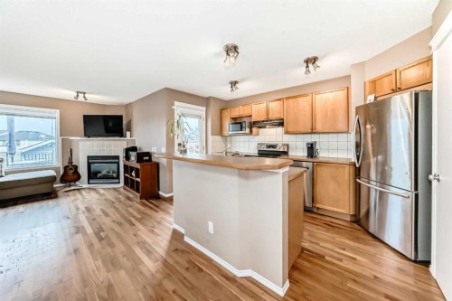 273 Tuscany Springs Way Nw, Calgary, AB - Indoor Photo Showing Kitchen With Fireplace